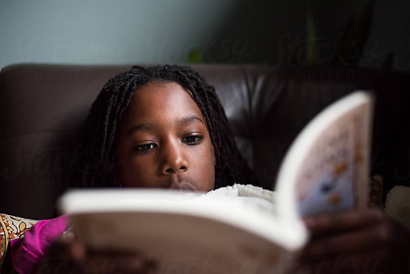 A student reads a book with focus