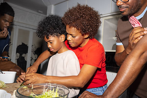 A family cooks together in the kitchen