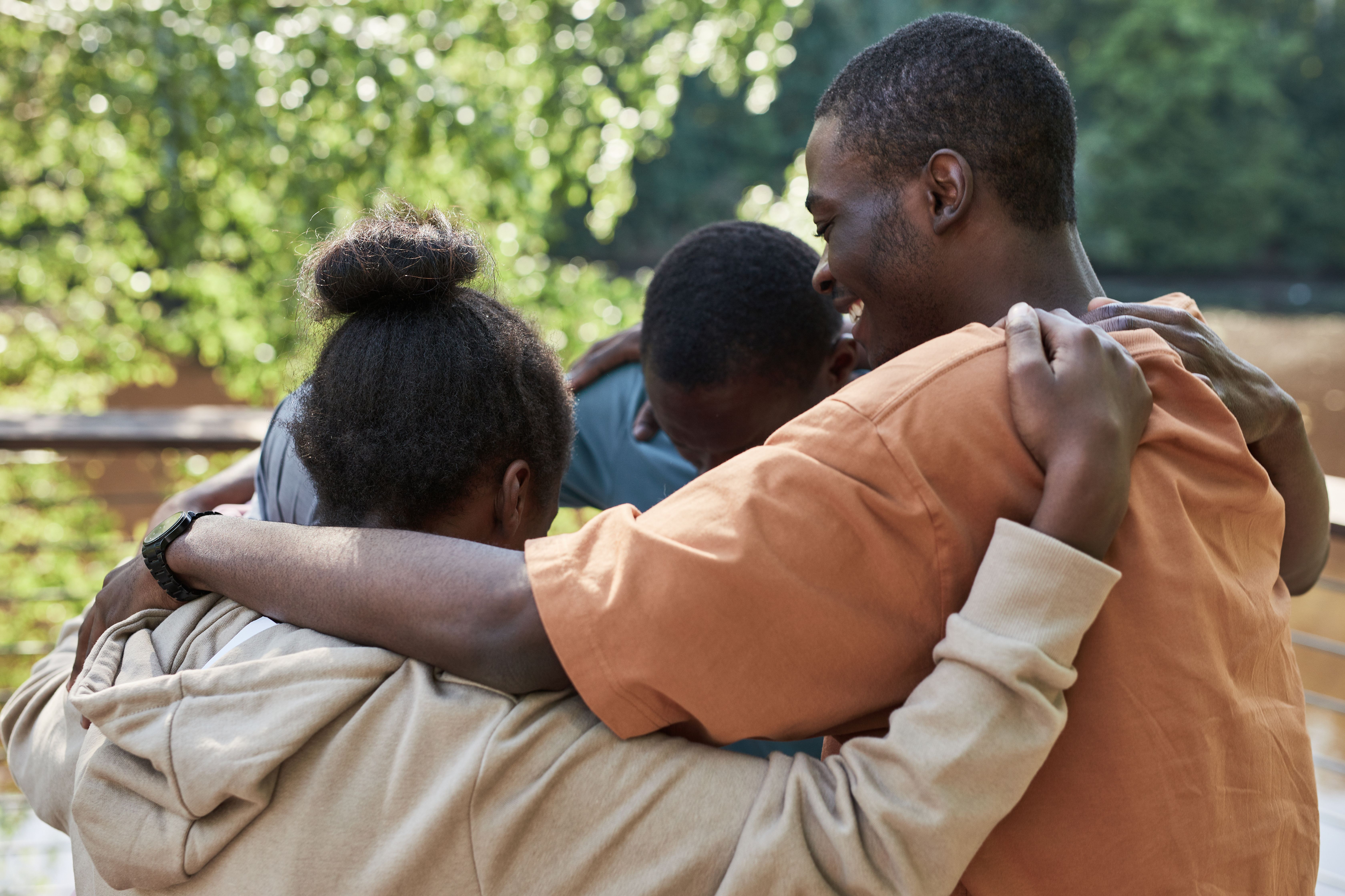 A family embraces together outdoors